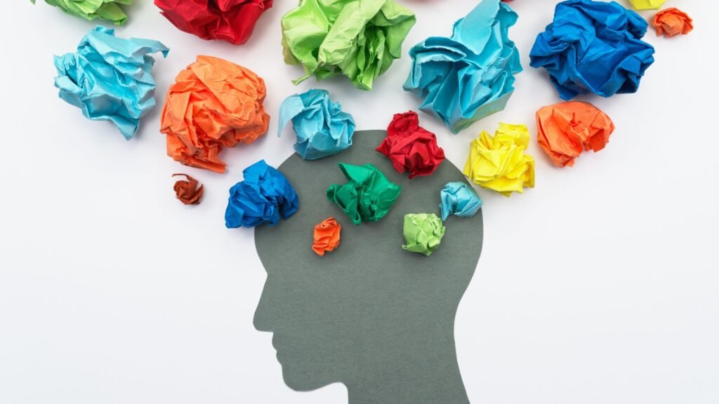 Color balls of paper coming from a hed represents emotions generated in the mind through storytelling